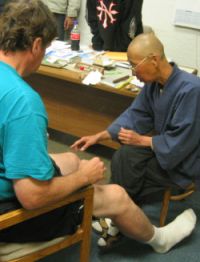 Bill's knee (not Wounded Knee!)receives the healing attentions of Jun San